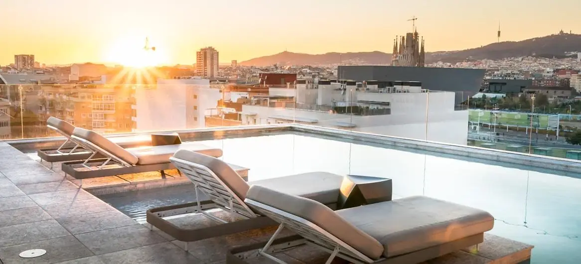 Rooftop pool with city skyline at sunset — hotel marketing ROI benchmarks 2026