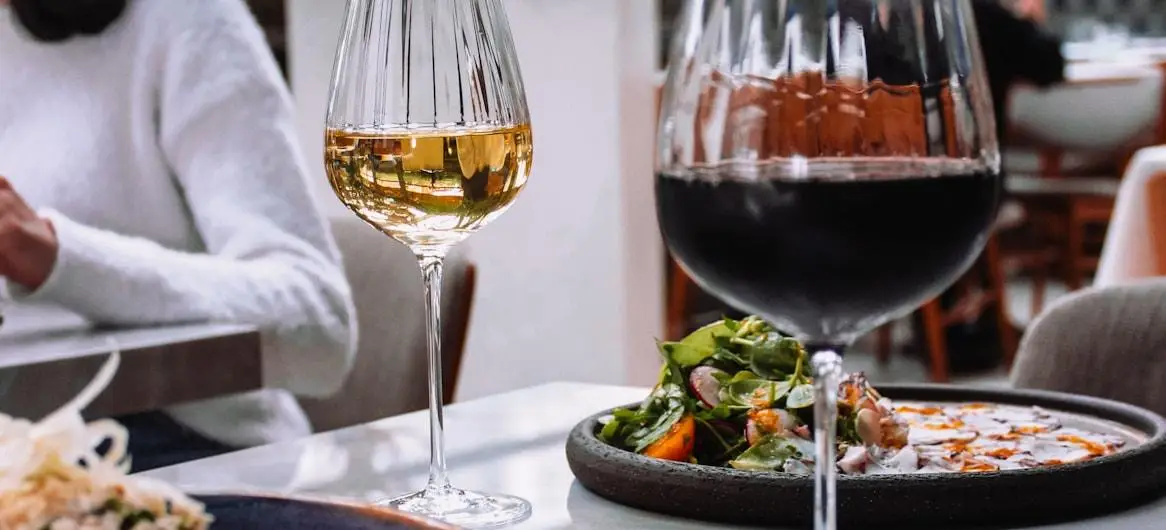 Woman dining at restaurant with wine — true cost of acquiring a restaurant diner 2026